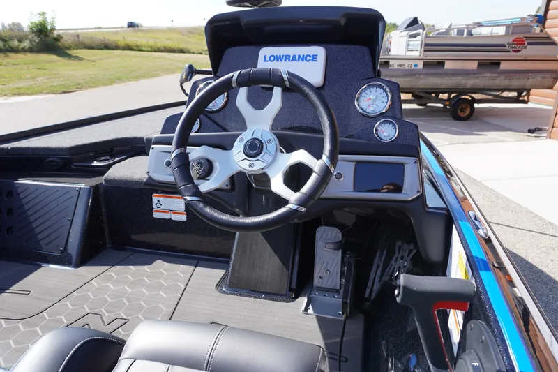 Slide: The Image of 2024 Nitro Z19 boat dashboard with steering wheel and gauges, featuring Lowrance electronics. - 55