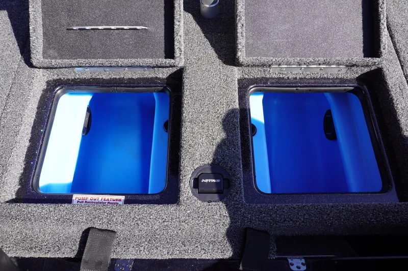 Slide: The Image of 2024 Nitro Z19 boat storage compartments with blue interiors and pump-out feature. - 57