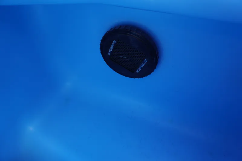 Slide: The Image of Close-up of a 2024 Nitro Z19 boat's oxygenator in a blue compartment. - 59