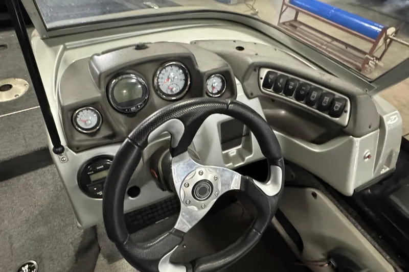 Slide: The Image of 2018 Tracker Targa V-19 WT boat dashboard with steering wheel and instrument panel. - 10