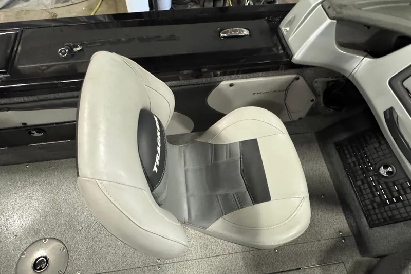 Slide: The Image of 2018 Tracker Targa V-19 WT boat interior with gray seating and console details. - 12