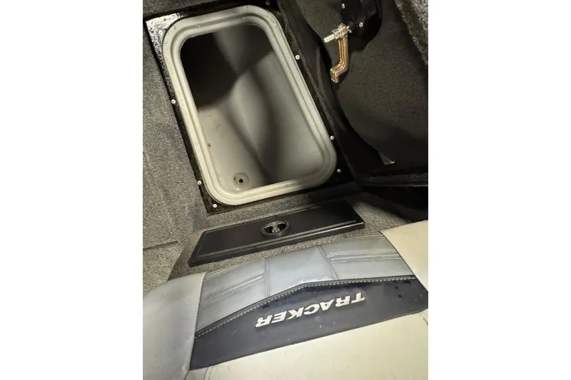 Slide: The Image of 2018 Tracker Targa V-19 WT boat storage compartment with open lid and visible interior. - 14