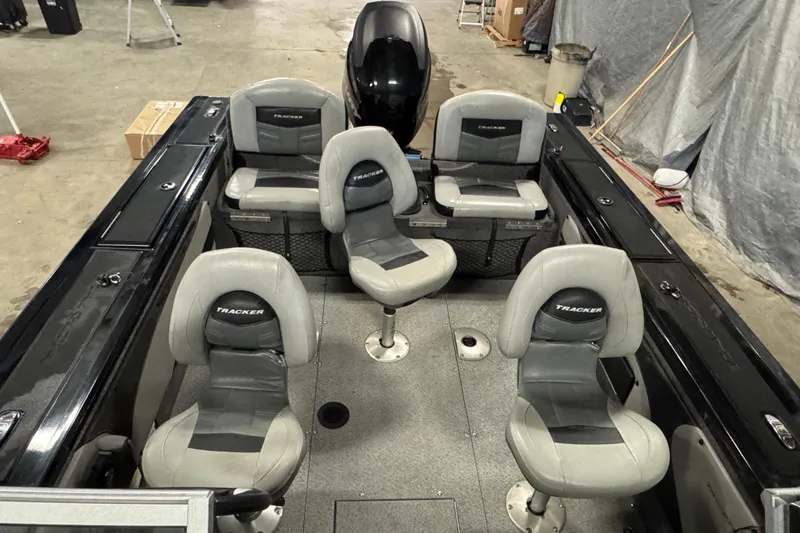Slide: The Image of 2018 Tracker Targa V-19 WT boat interior with five gray seats in a garage setting. - 17