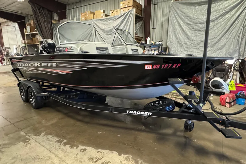 Slide: The Image of 2018 Tracker Targa V-19 WT boat on trailer in a garage setting. - 2