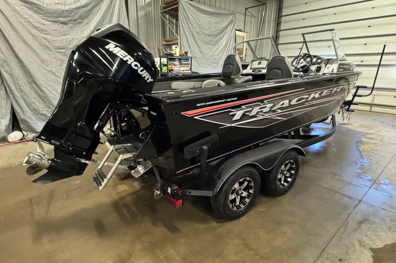 Slide: The Image of 2018 Tracker Targa V-19 WT boat with Mercury engine in a garage setting. - 3