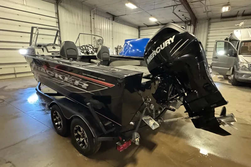 Slide: The Image of 2018 Tracker Targa V-19 WT boat with Mercury engine in a garage setting. - 4