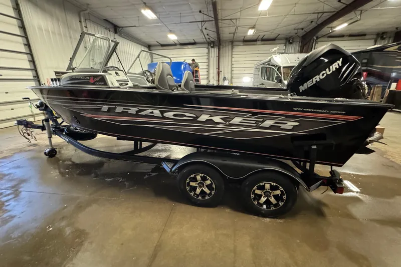 Slide: The Image of 2018 Tracker Targa V-19 WT boat with Mercury engine in a garage setting. - 5