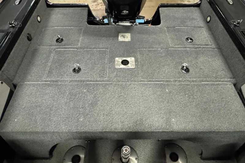 Slide: The Image of 2018 Tracker Targa V-19 WT boat interior with storage compartments and carpeted deck. - 6