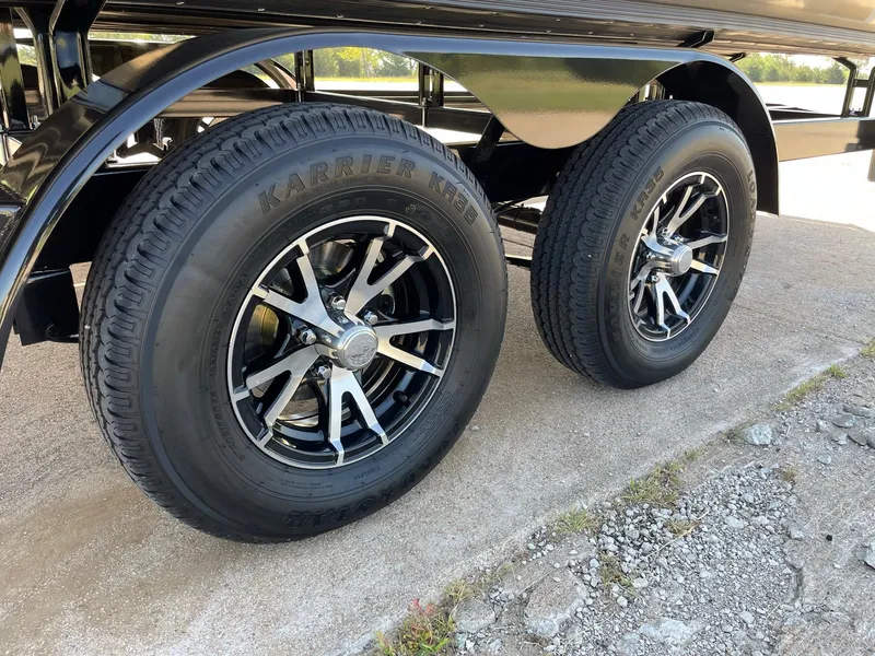 Slide: The Image of 2024 Barletta Lusso 25UCA trailer wheels on concrete surface. - 17