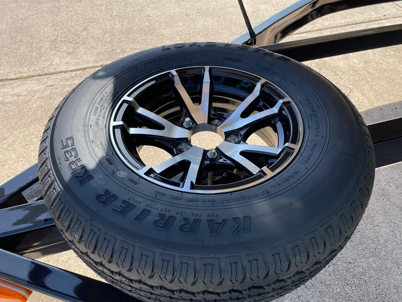 Slide: The Image of 2024 Barletta Lusso 25UCA spare tire with black alloy wheel. - 18