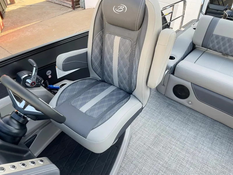 Slide: The Image of 2024 Barletta Lusso 25UCA boat interior with luxurious captain's chair and modern dashboard. - 26