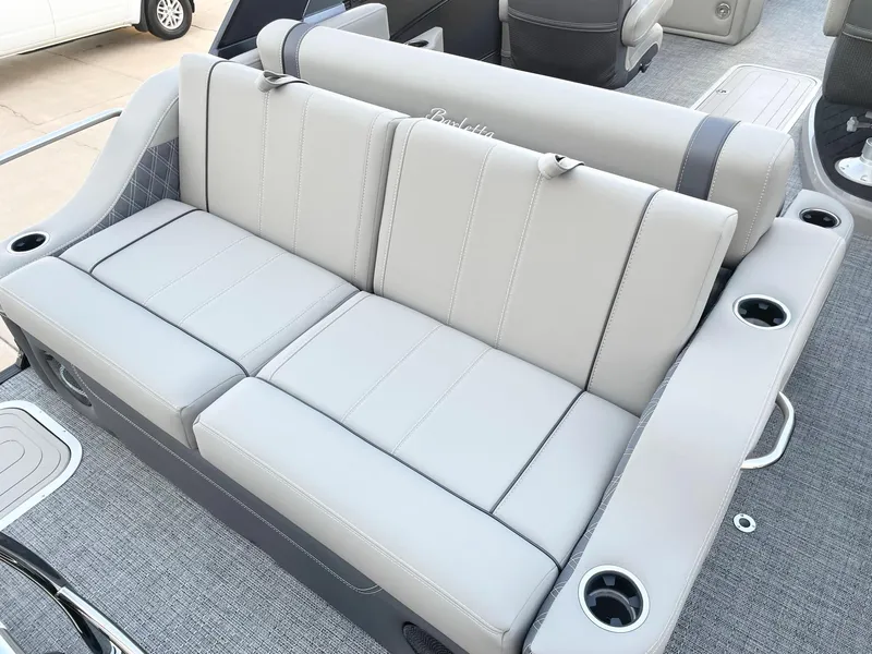Slide: The Image of 2024 Barletta Lusso 25UCA boat interior with luxurious seating and cup holders. - 37