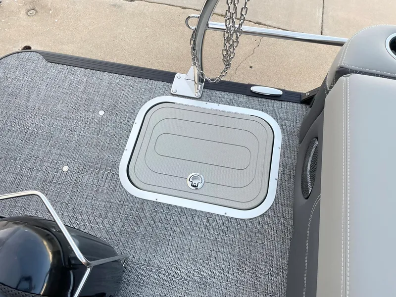 Slide: The Image of 2024 Barletta Lusso 25UCA boat deck with storage hatch and chain railing. - 38