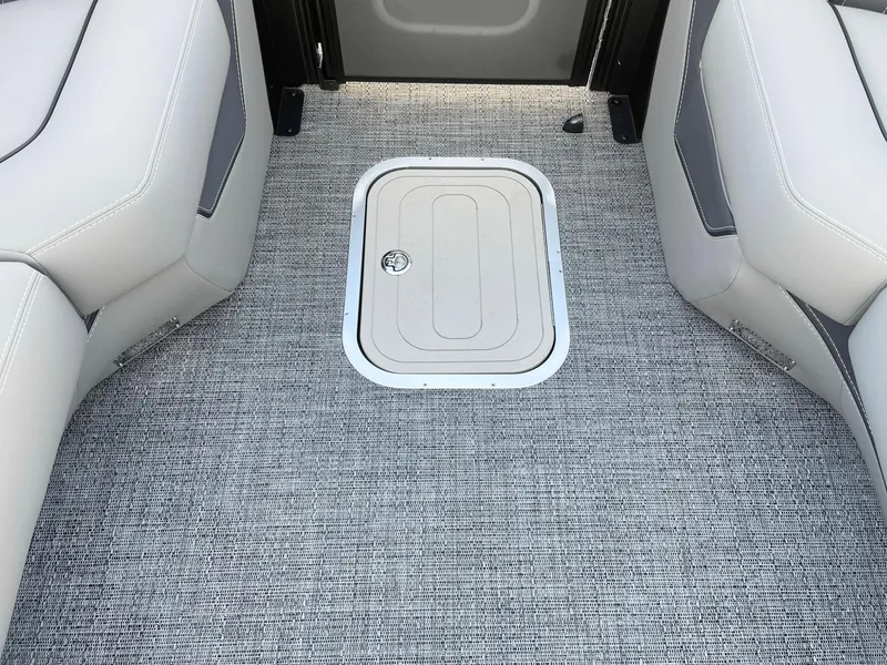 Slide: The Image of 2024 Barletta Lusso 25UCA interior with gray carpet and storage hatch. - 45