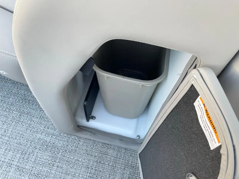 Slide: The Image of 2024 Barletta Lusso 25UCA storage compartment with built-in trash bin, featuring sleek design and functionality. - 49