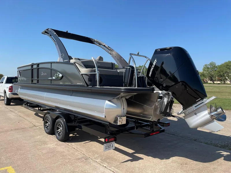 Slide: The Image of 2024 Barletta Lusso 25UCA pontoon boat with Mercury outboard engine on trailer. - 6