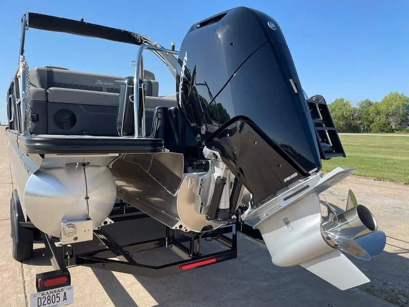 Slide: The Image of 2024 Barletta Lusso 25UCA pontoon boat with powerful outboard motor. - 7