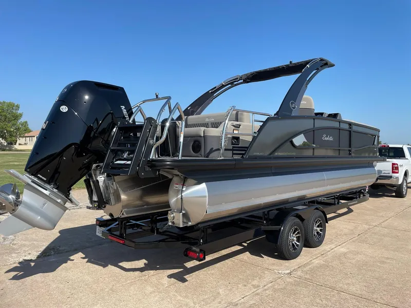 Slide: The Image of 2024 Barletta Lusso 25UCA pontoon boat on trailer with outboard motor. - 9