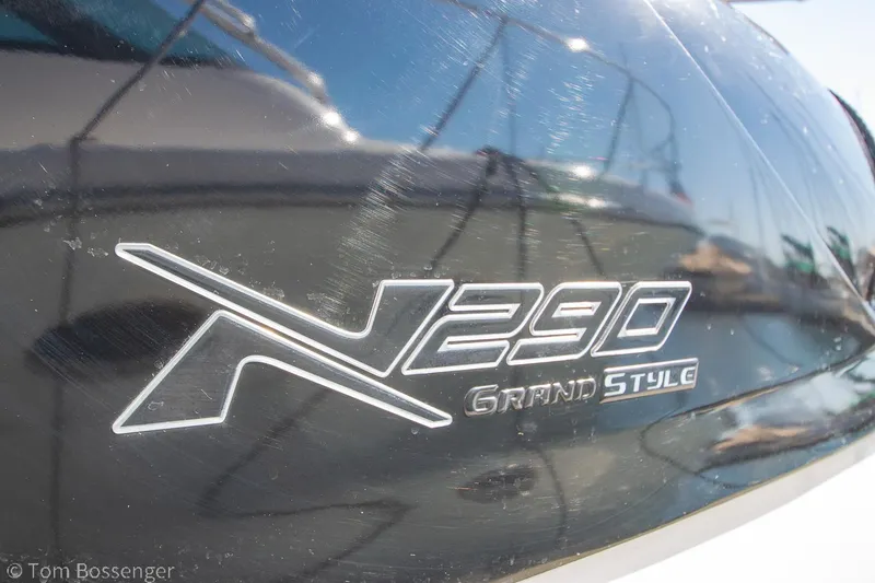 Slide: The Image of 2023 NX Boats 290 Exclusive Edition logo on sleek black surface. - 10