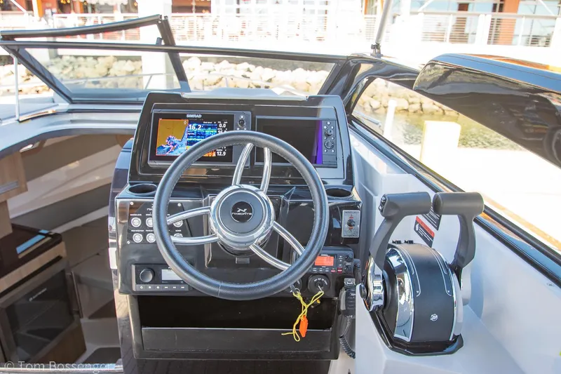 Slide: The Image of Helm of 2023 NX Boats 290 Exclusive Edition with modern controls and navigation display. - 22