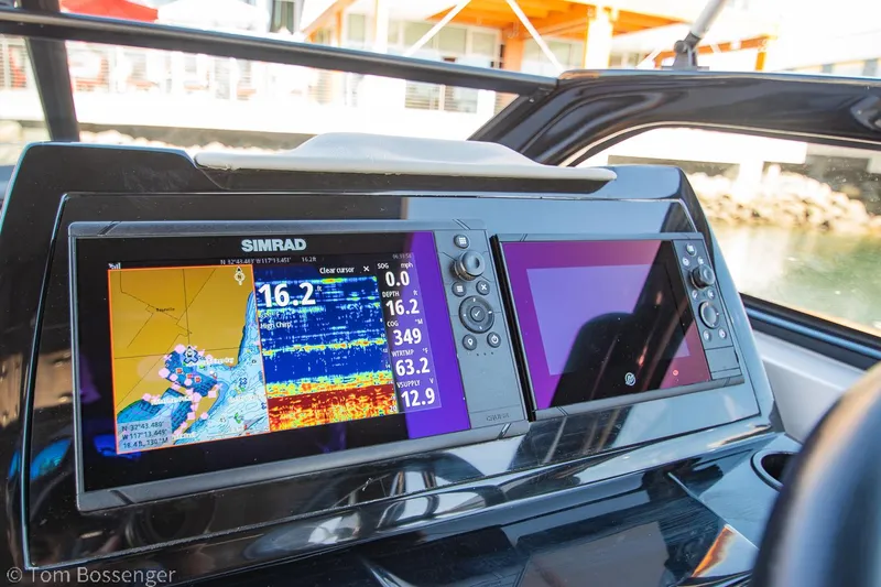 Slide: The Image of 2023 NX Boats 290 Exclusive Edition dashboard with dual Simrad navigation displays. - 23