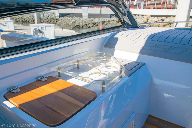 Slide: The Image of 2023 NX Boats 290 Exclusive Edition interior with wooden accents and cup holders. - 27