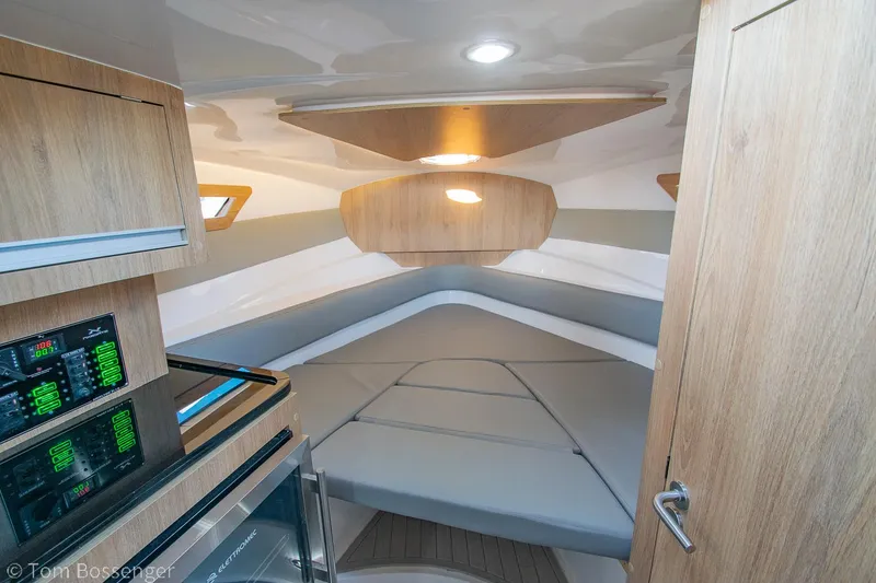 Slide: The Image of 2023 NX Boats 290 Exclusive Edition cabin interior with modern design and comfortable seating. - 29