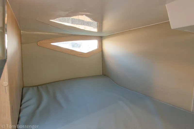 Slide: The Image of Interior cabin of 2023 NX Boats 290 Exclusive Edition, featuring a cozy sleeping area. - 33