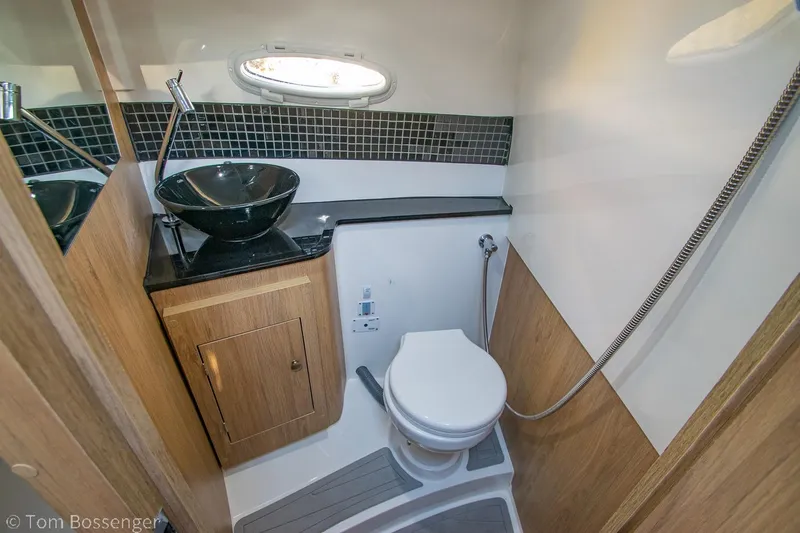 Slide: The Image of Luxurious bathroom in 2023 NX Boats 290 Exclusive Edition with modern fixtures and wood accents. - 35