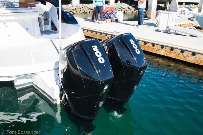 Slide: The Image of Twin Mercury 200 engines on a 2023 NX Boats 290 Exclusive Edition at a dock. - 38
