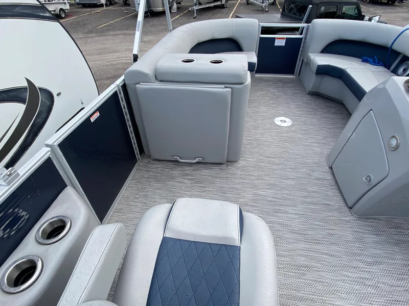 Slide: The Image of 2022 Bennington 22LSR pontoon boat interior with gray and blue seating. - 12