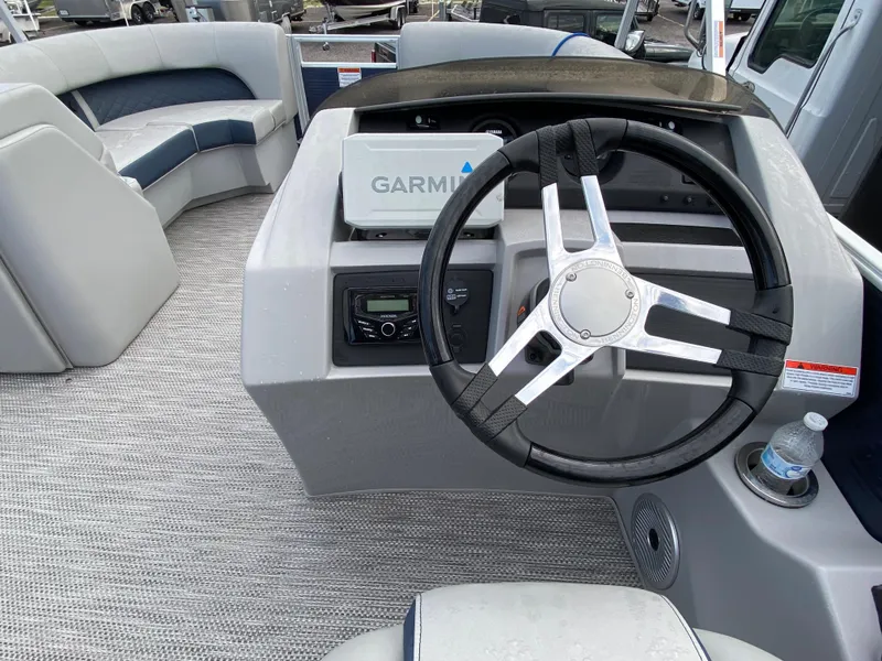 Slide: The Image of 2022 Bennington 22LSR boat interior with Garmin navigation system and steering wheel. - 13