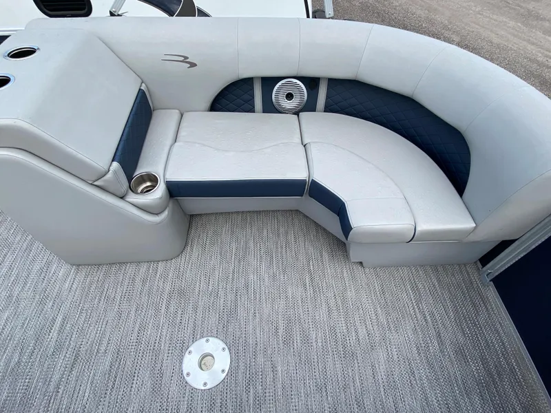Slide: The Image of 2022 Bennington 22LSR boat interior with cushioned seating and cup holders. - 17