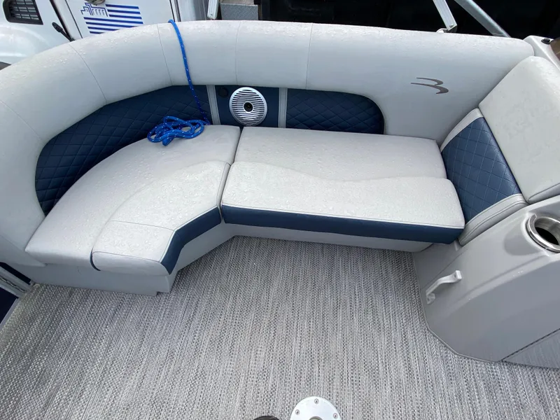 Slide: The Image of 2022 Bennington 22LSR boat interior seating with blue and white upholstery. - 18