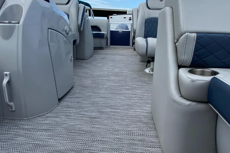 Slide: The Image of Interior of a 2022 Bennington 22LSR pontoon boat with gray and blue seating. - 25