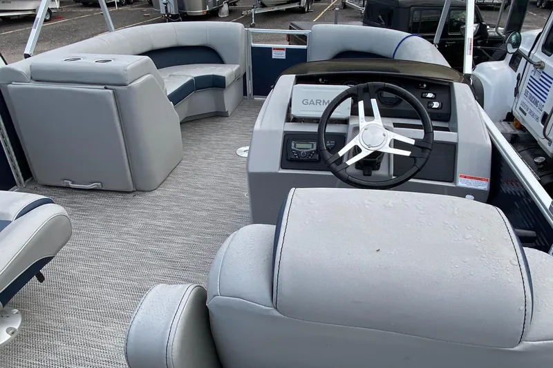Slide: The Image of 2022 Bennington 22LSR pontoon boat interior with steering console and seating. - 28