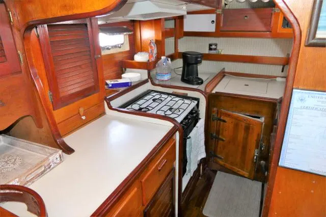 Slide: The Image of 1979 Roberts 54 boat kitchen with wooden cabinetry, stove, and countertop. - 10