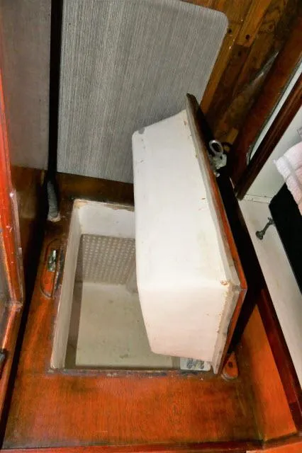 Slide: The Image of Open storage compartment in a 1979 Roberts 54 boat. - 13