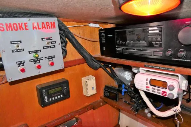 Slide: The Image of Boat control panel with smoke alarm, radio, and navigation equipment in a 1979 Roberts 54. - 15