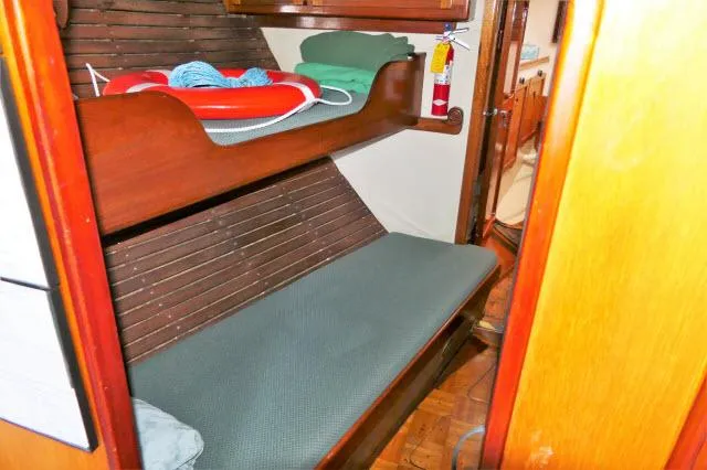 Slide: The Image of 1979 Roberts 54 boat interior with bunk beds and safety equipment. - 17