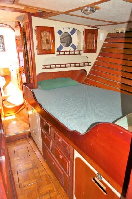 Slide: The Image of Cozy cabin interior of a 1979 Roberts 54 sailboat with wooden furnishings. - 19
