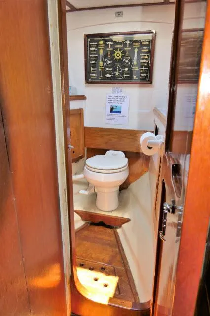 Slide: The Image of 1979 Roberts 54 boat bathroom with wooden interior and nautical decor. - 20