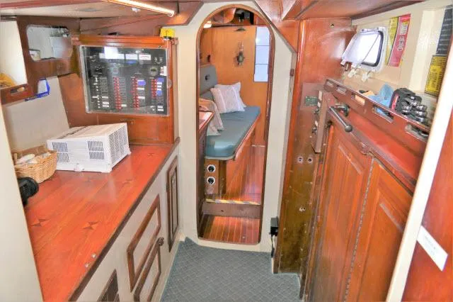 Slide: The Image of 1979 Roberts 54 boat interior with wooden cabinetry and cozy sleeping area. - 21