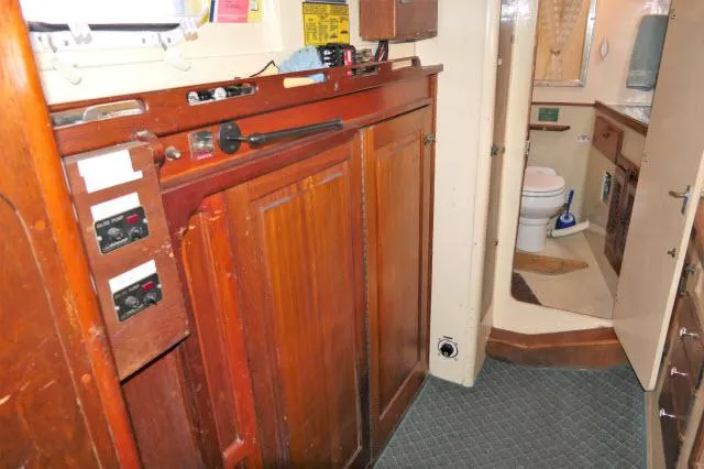 Slide: The Image of 1979 Roberts 54 boat interior with wooden cabinets and bathroom. - 22