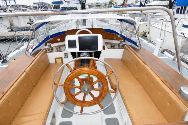 Slide: The Image of Cockpit of a 1979 Roberts 54 sailboat with wooden steering wheel and navigation equipment. - 31
