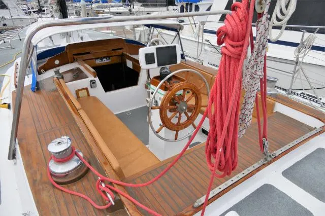 Slide: The Image of 1979 Roberts 54 sailboat cockpit with wooden wheel and navigation equipment. - 32