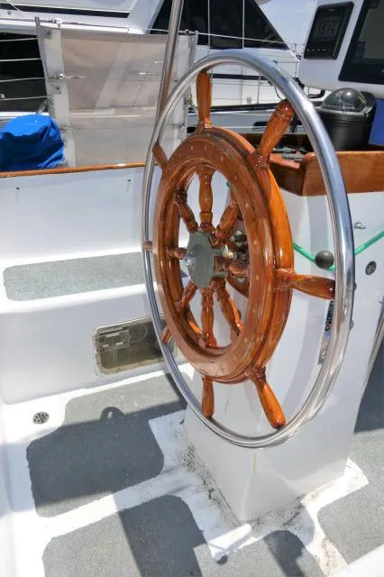 Slide: The Image of Wooden ship wheel on a 1979 Roberts 54 sailboat. - 34