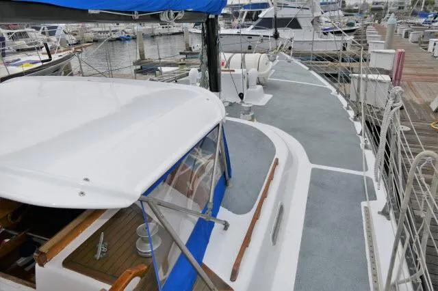 Slide: The Image of 1979 Roberts 54 sailboat docked at marina, view of deck and cockpit. - 44