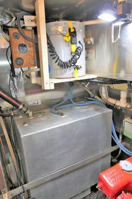 Slide: The Image of Engine room of a 1979 Roberts 54 boat with fuel tank and electrical panel. - 49