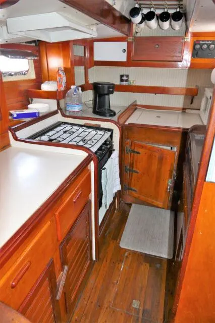 Slide: The Image of 1979 Roberts 54 boat kitchen with wooden cabinets, stove, and countertop. - 9